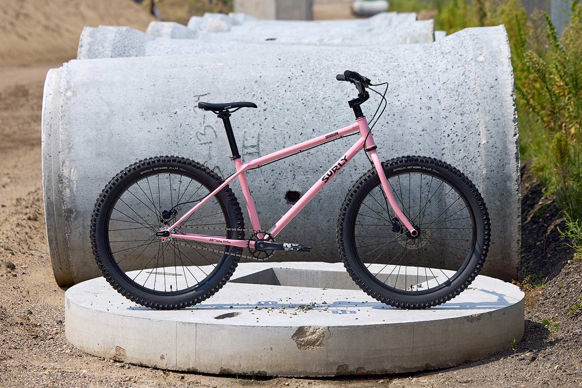 Surly Lowside bike side view in New Pig Smell color, concrete in background
