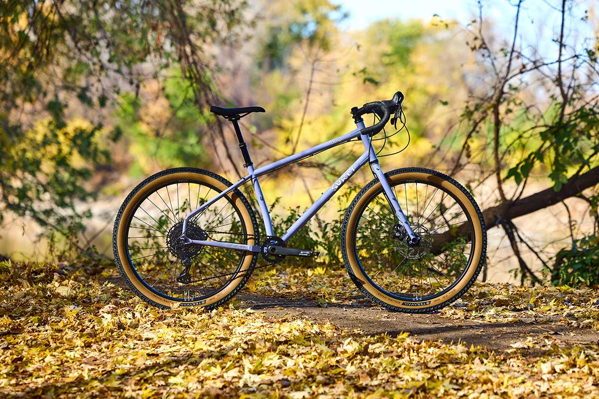 Surly Grappler bike side view in forest next to singletrack