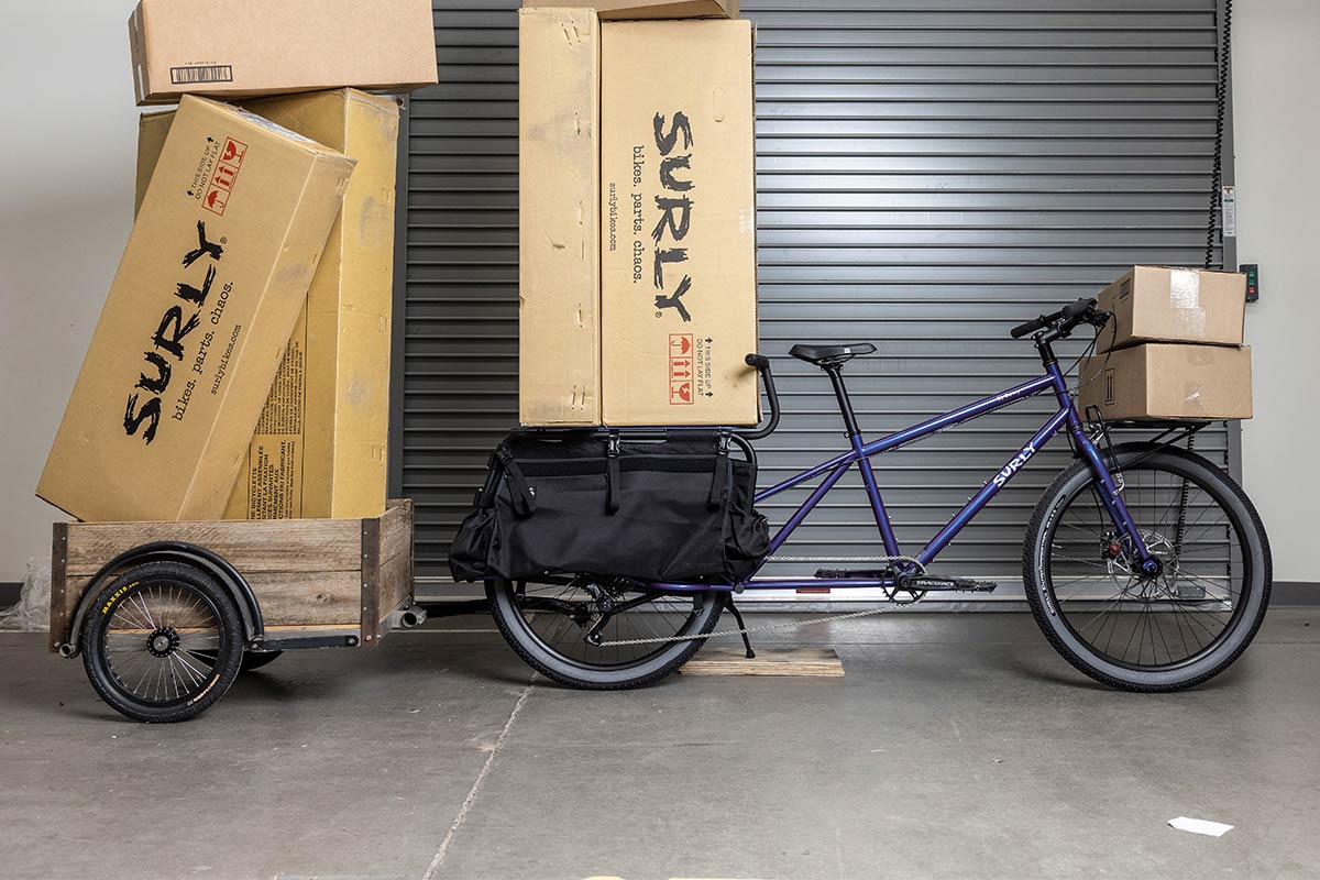 Surly Big Dummy fully loaded with front rack, trailer, and many cardboard boxes loaded everywhere