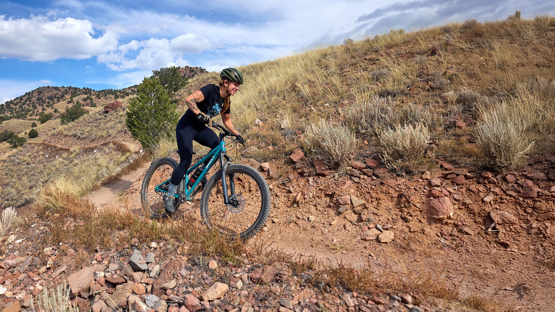 Person riding Surly Karate Monkey on open rock trail