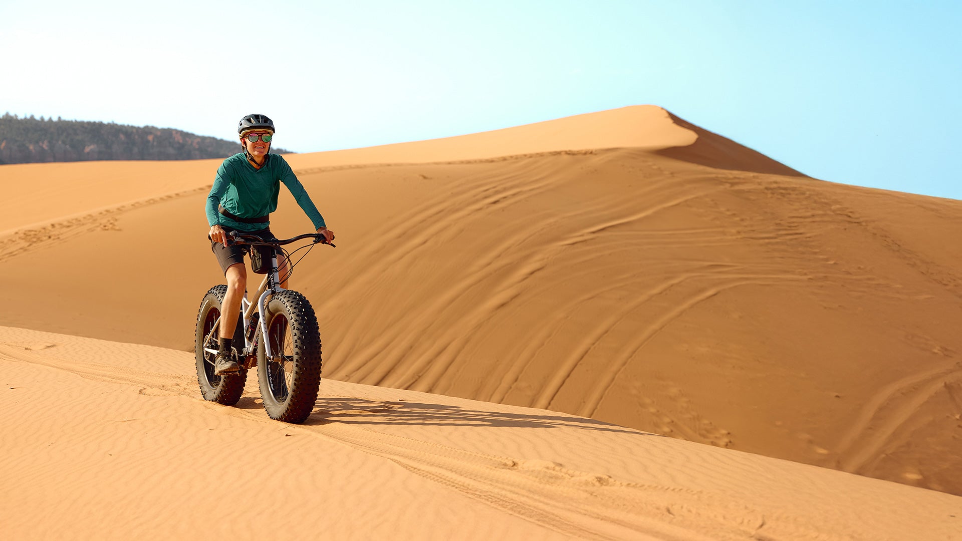 Person riding Surly Moonlander on sand dunes