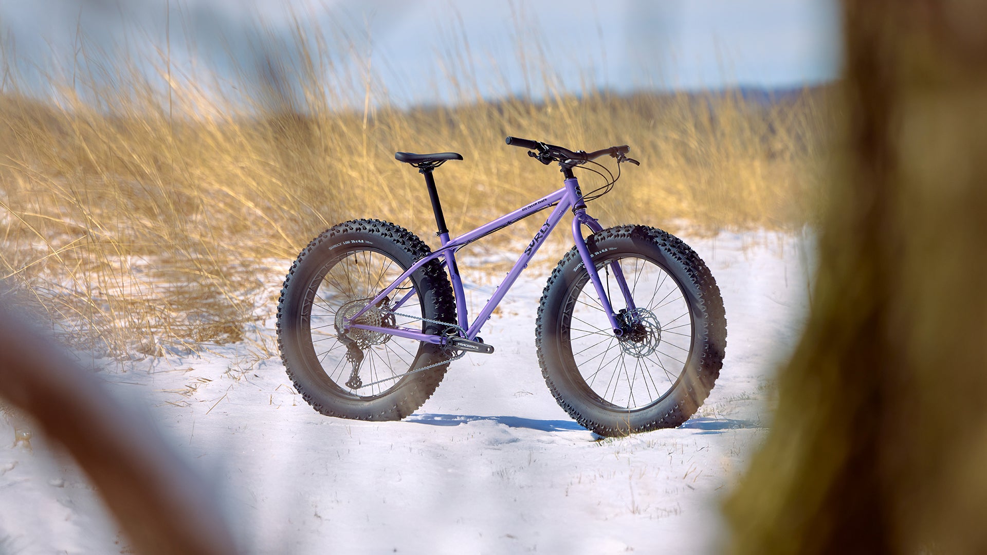 Surly Ice Cream Truck purple color side view outside on snow and grass landscape