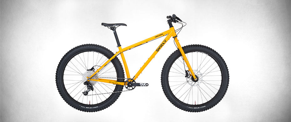 Surly Karate Monkey bike with rigid fork "Rhymes With" Orange color side view