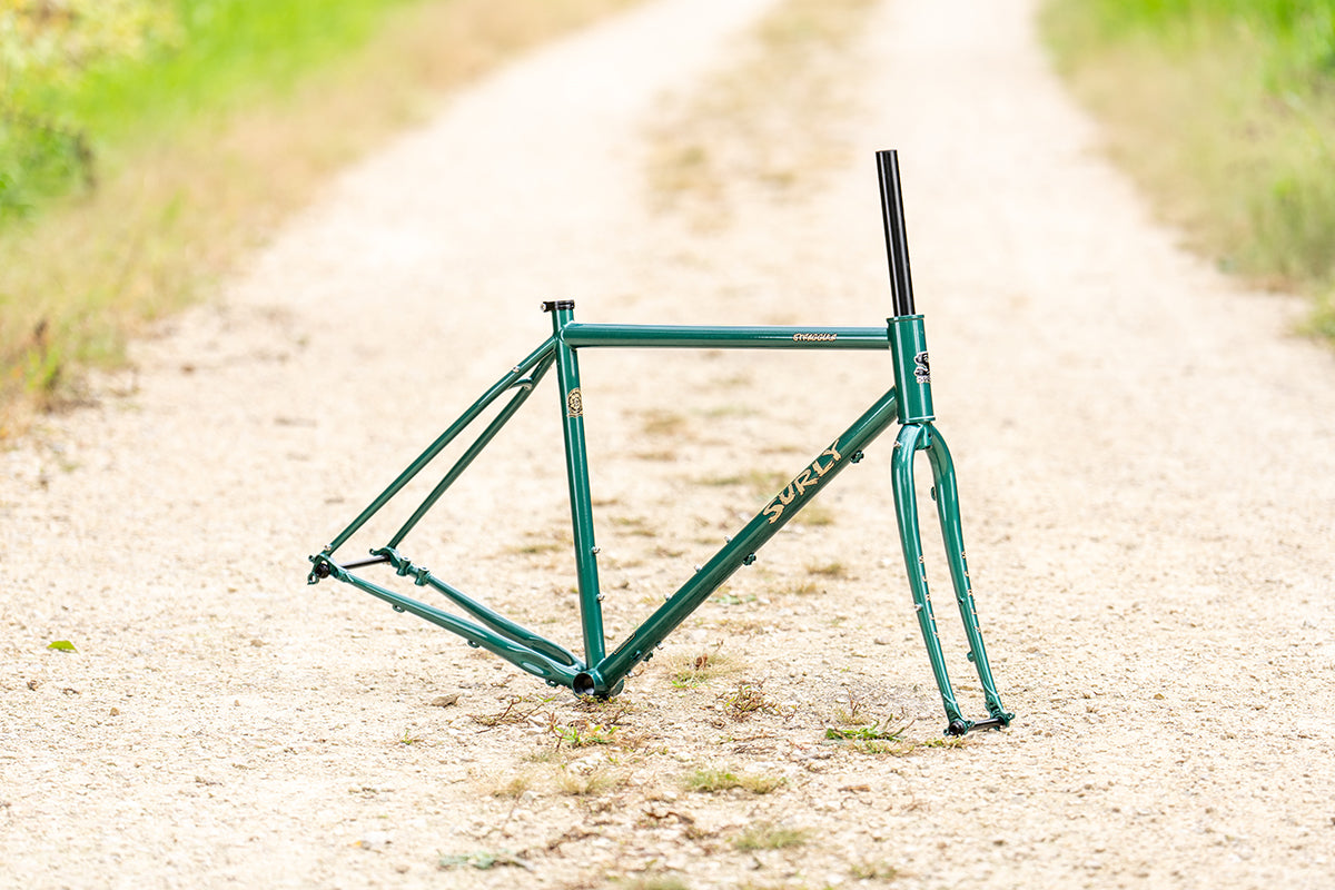 Surly Straggler Frameset in Subtropic Algae color side view outside on gravel road