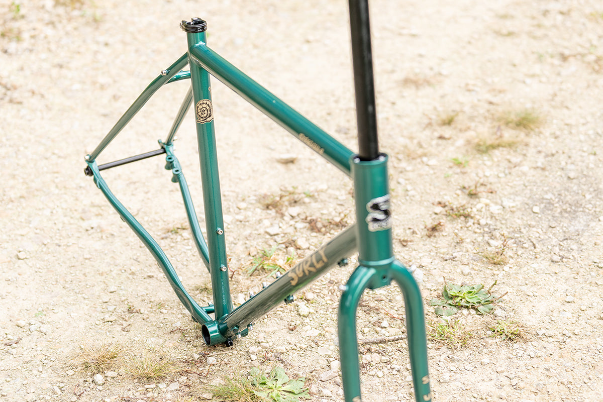 Surly Straggler Frameset in Subtropic Algae color front three-quarter view looking down focus on seat tube on gravel road