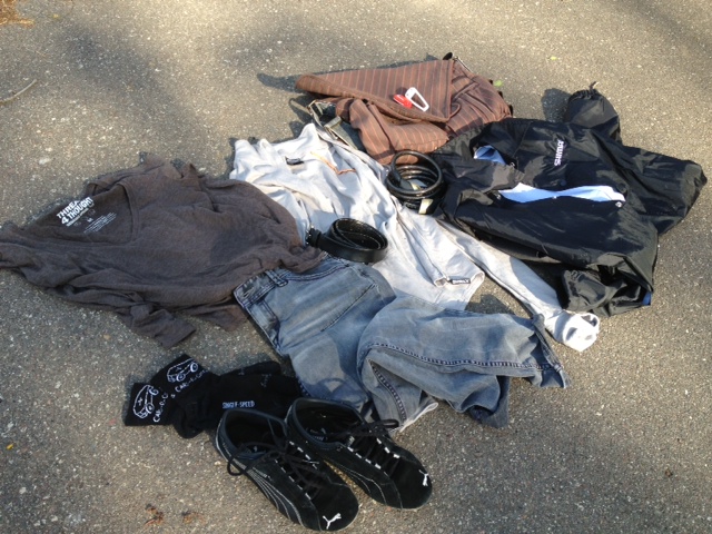 Downward view of clothing laying on pavement