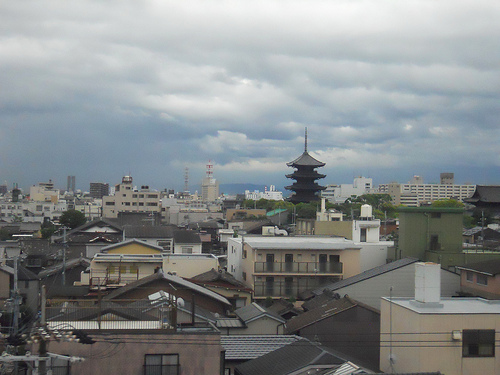 Buildings of a Japanese city with dark clouds in the sky