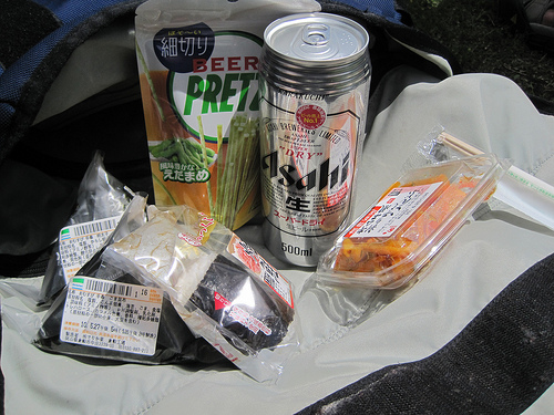 A variety of packaged Japanese food items and an unopened beverage can
