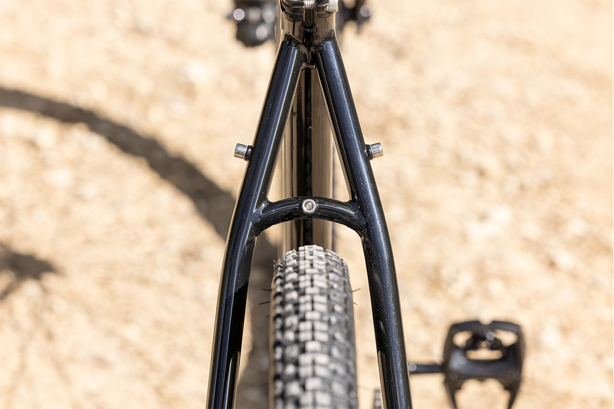 Close-up of a bicycle frame and tire on a blurred background