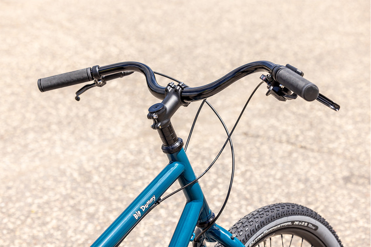 Surly Big Dummy cargo bike detailed view of front of bike showing stem and handlebars outside on pavement