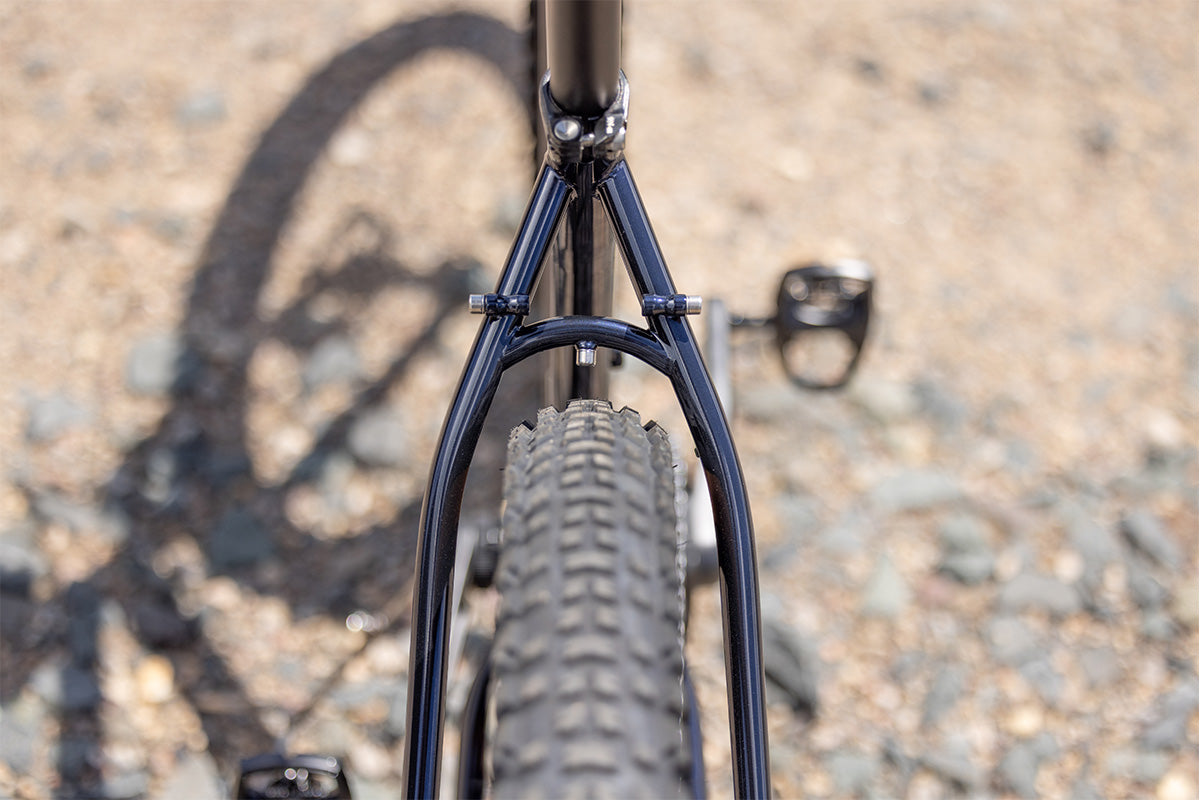 Surly Bridge Club bike outside showing rear tire clearance on a blurred gravel background