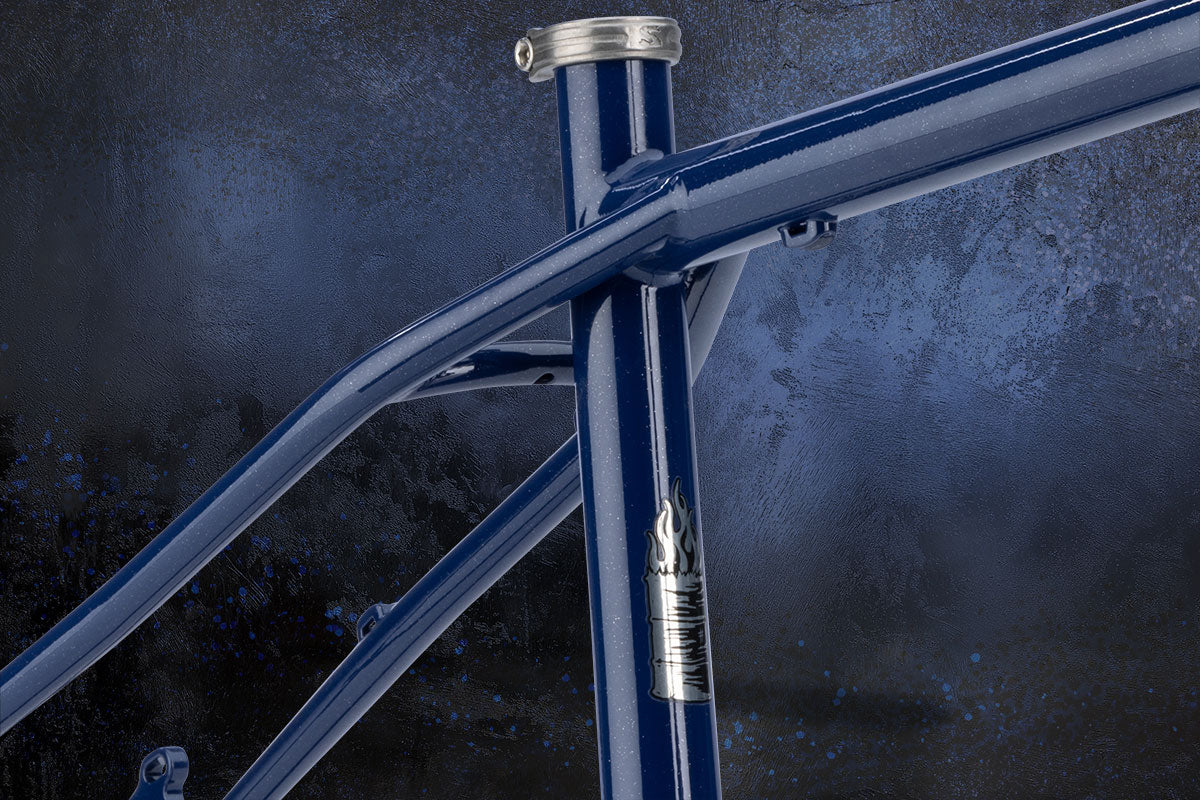 Close-up of a blue bicycle frame with a dark background