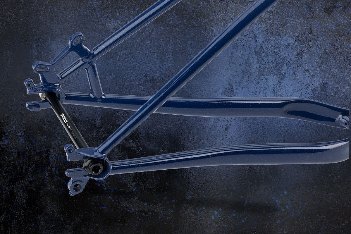 Bicycle frame focus on rear dropout on a dark textured background