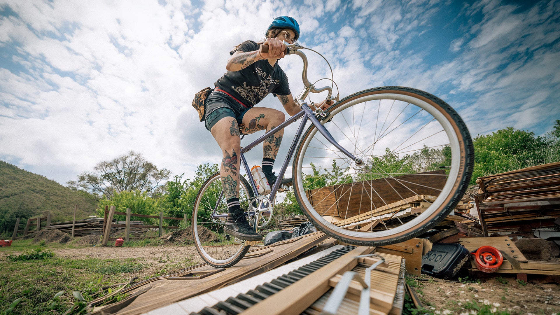 Person riding a Steamroller on wooden ramps with a scenic background