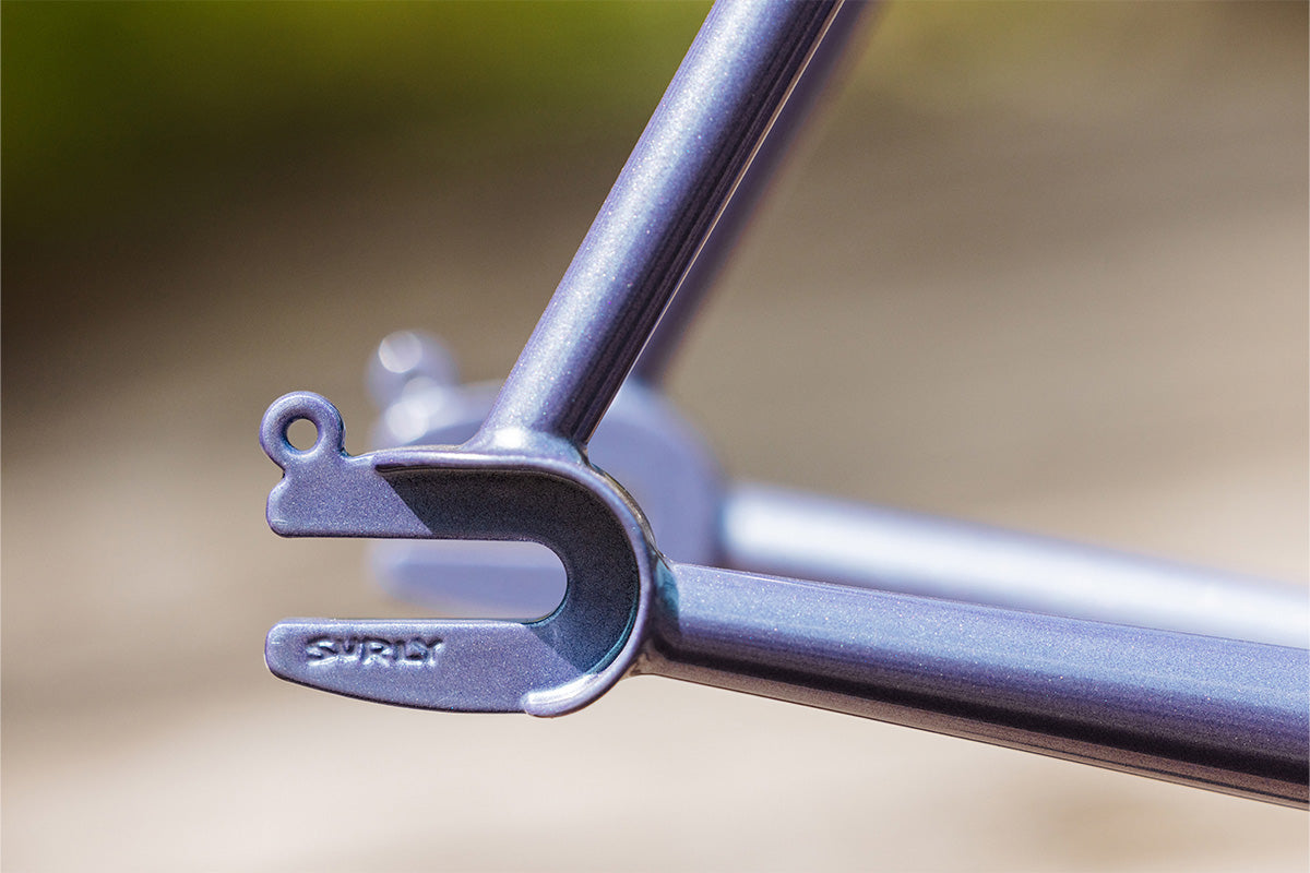 Close-up of rear track dropouts on Steamroller frame outside with blurry background