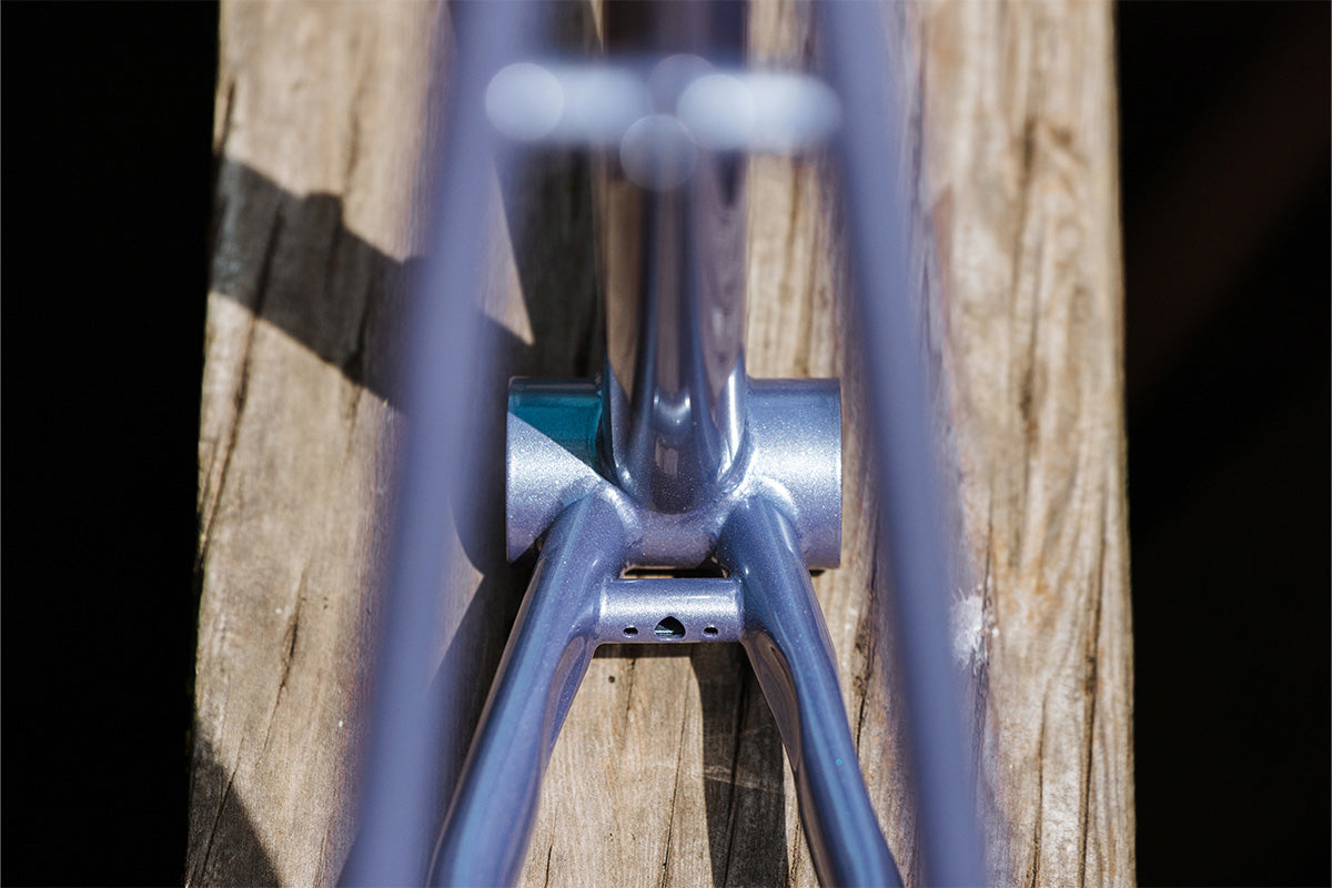Close-up of a Steamroller frame focus on bottom bracket frame on a wooden surface