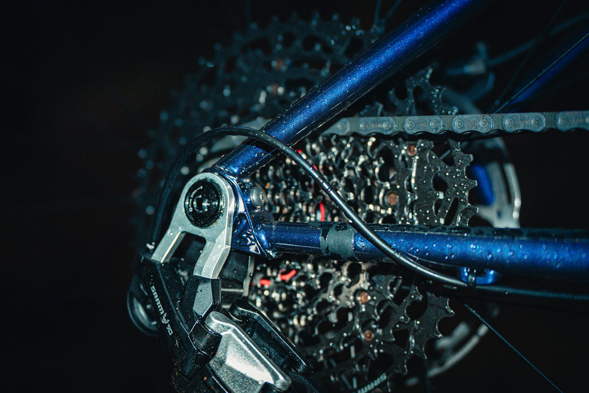 Close-up of a bicycle's gear system on a dark background