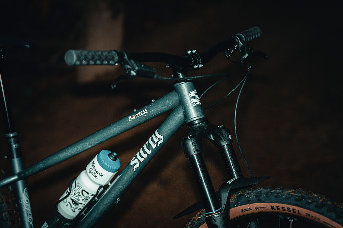 Close-up of a bicycle with visible branding on a dark background