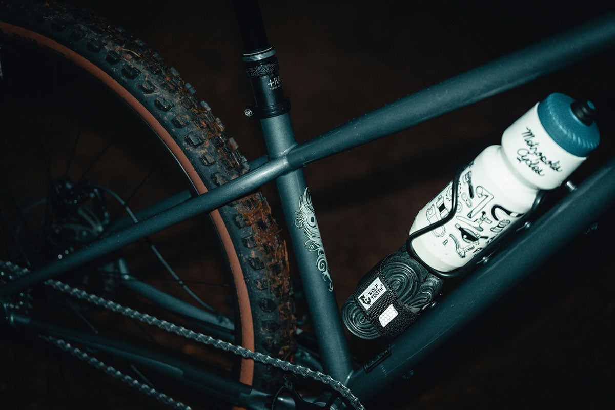 Close-up of a bicycle with water bottles attached on a dark background