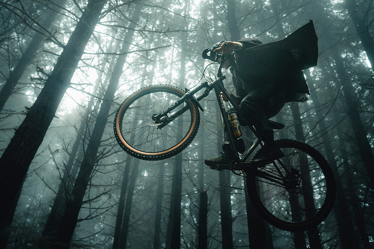 Person on a mountain bike in a foggy forest