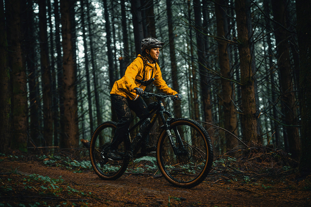 Person riding a bicycle through a forest