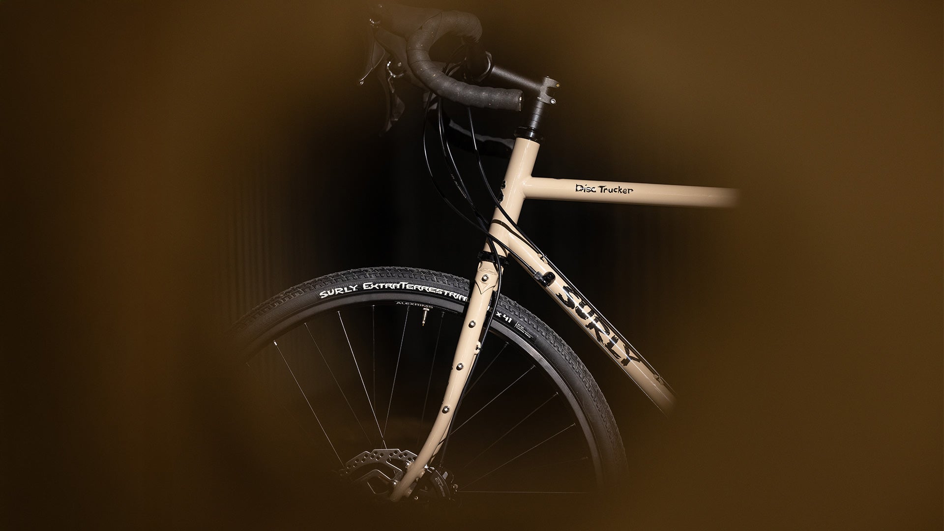 Surly Disc Trucker bike in Grandpa's Khakis colorway on blurry background