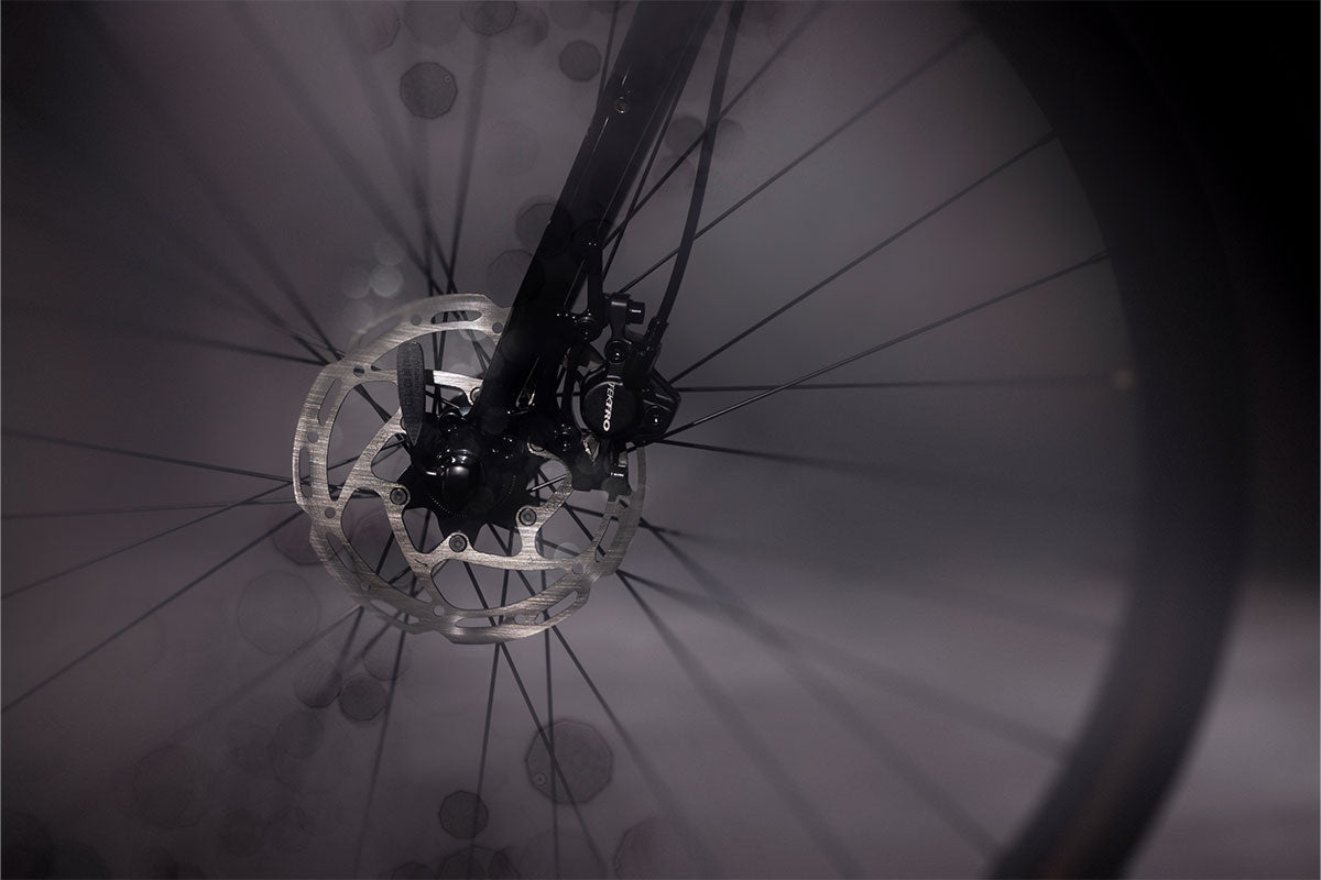 Close-up of a bicycle wheel with focus on the hub and spokes.