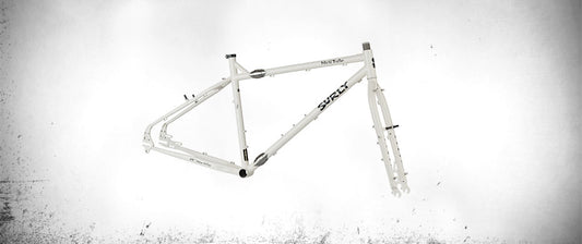 Surly World Troller frameset Milque color side view showing frame couplers on top and down tubes