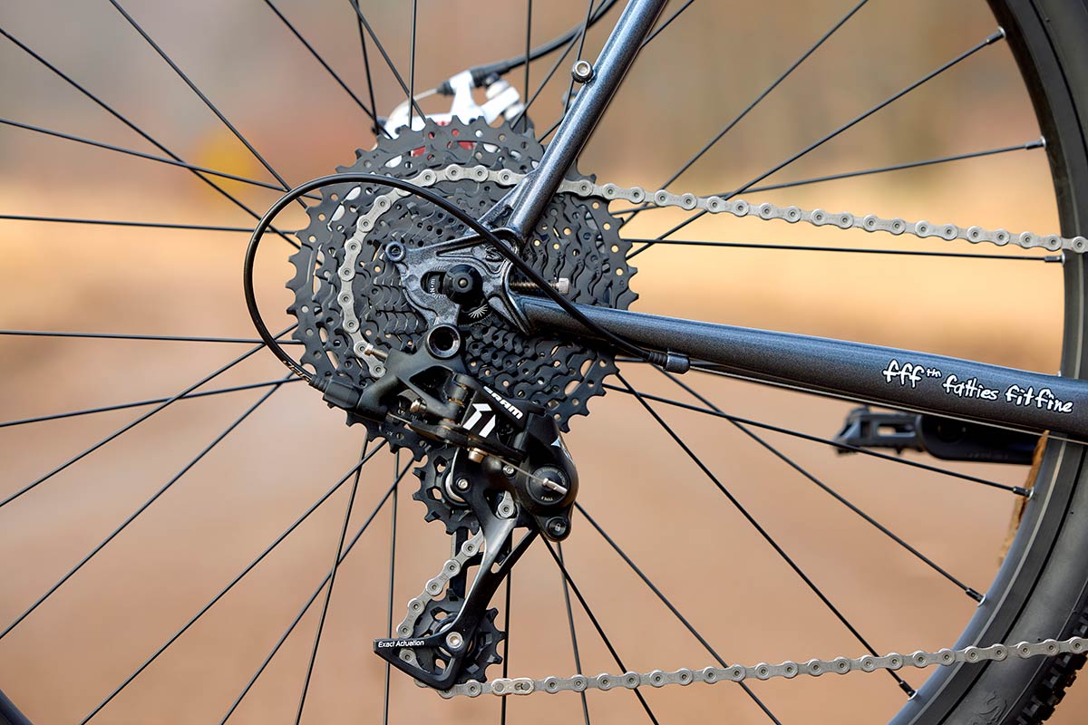 Surly Straggler detail of rear dropout, rear derailleur, cassette, and spokes