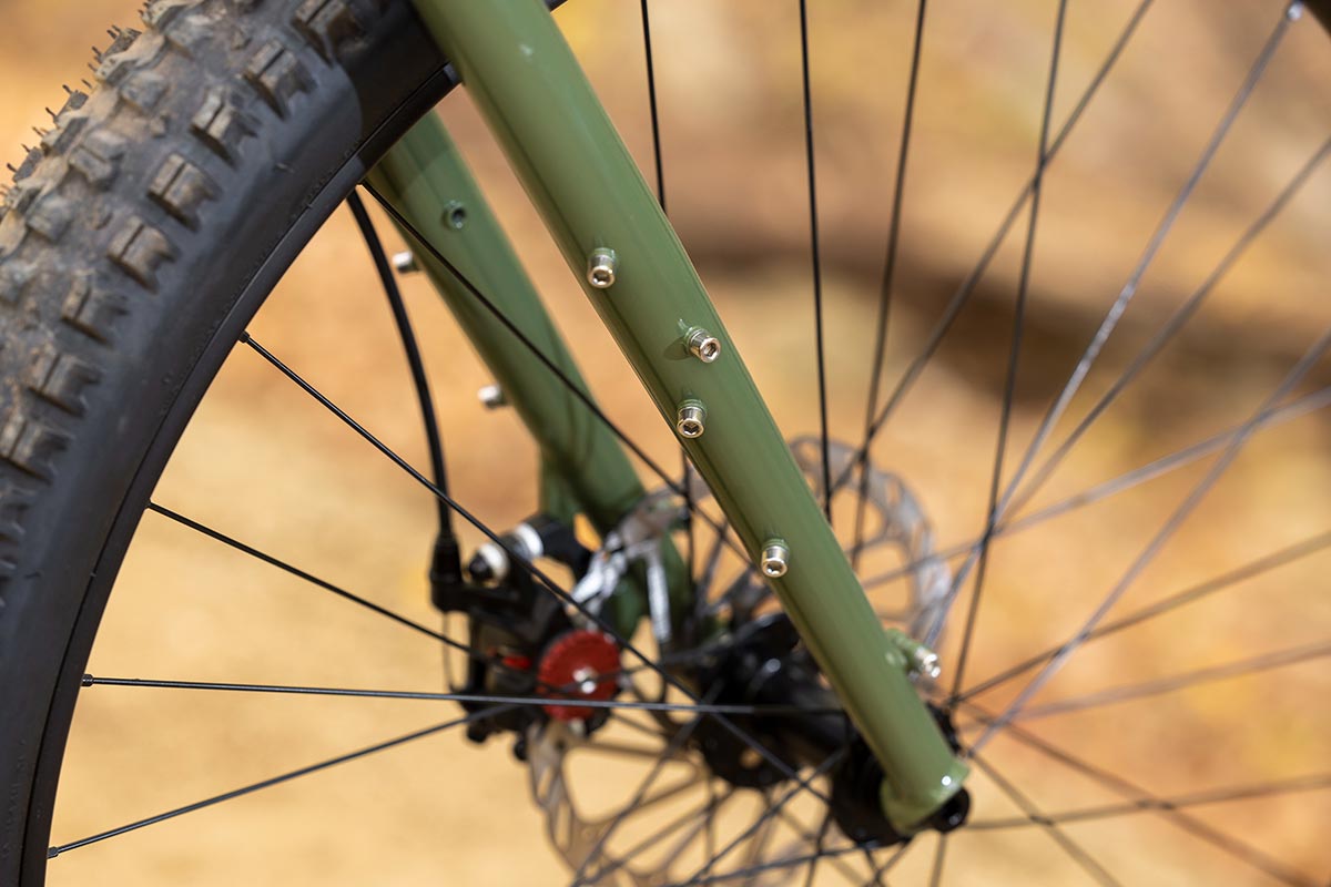 Surly Krampus rigid for detail on British Racing Green color bike showing 3-pack, fender mounts, and disc caliper