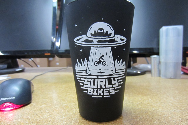 Front view of a Surly Bikes pint glass, black