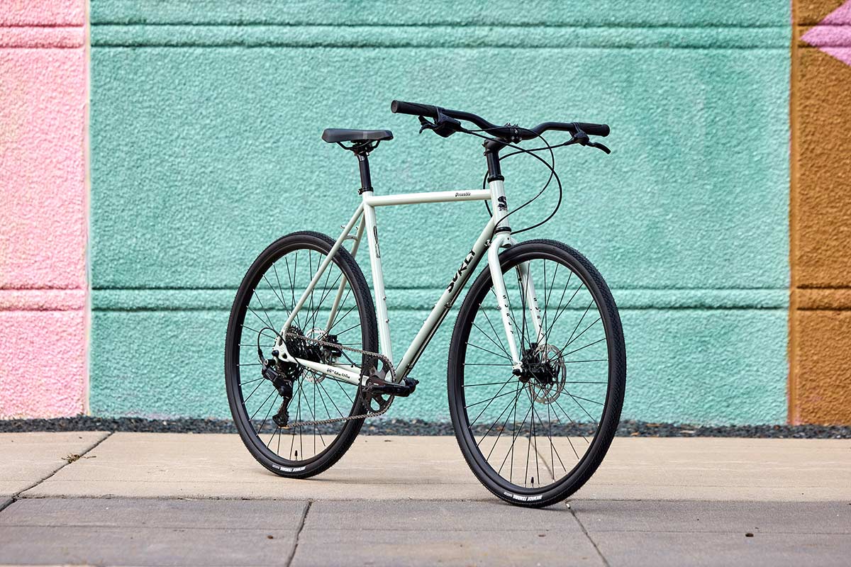 Surly Preamble Flat Bar Best Buds Green bike three-quarter front view on on sidewalk up against teal exterior wall