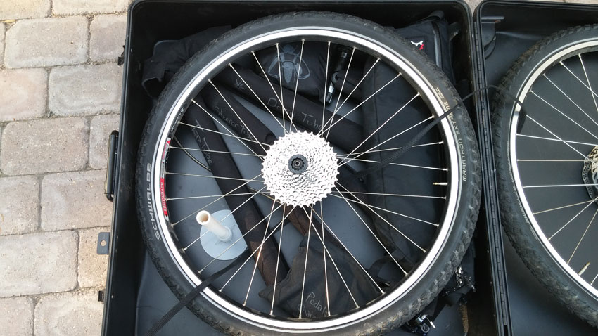 Downward of the rear wheel of a Surly World Troller bike, packed in a bike carrier case