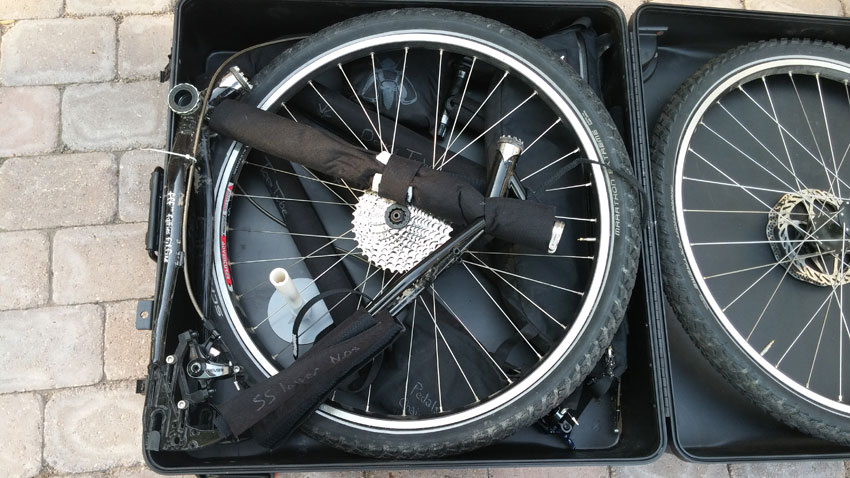 Downward view of the rear frame section of a Surly World Troller bike, pack on the rear wheel, in a bike carrier case