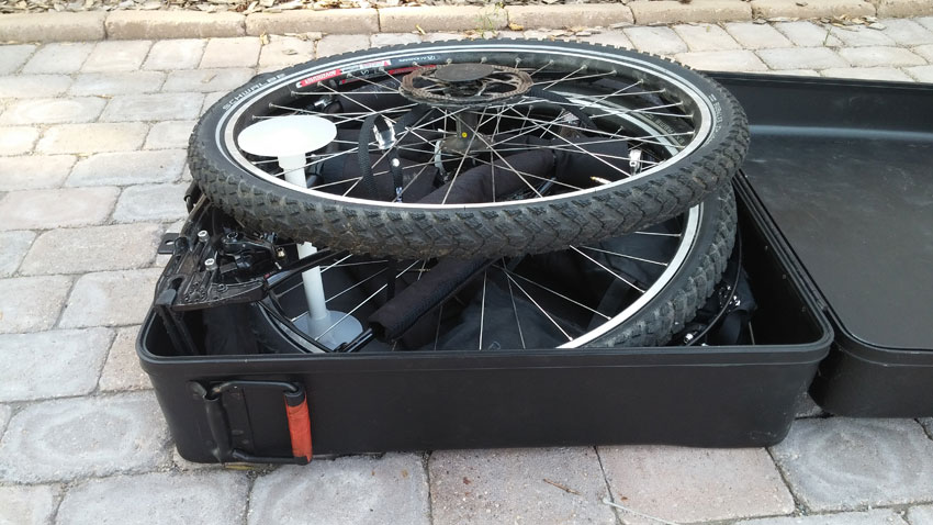 Front, angled view of a disassembled Surly World Troller bike, packed in an open bike carrier case