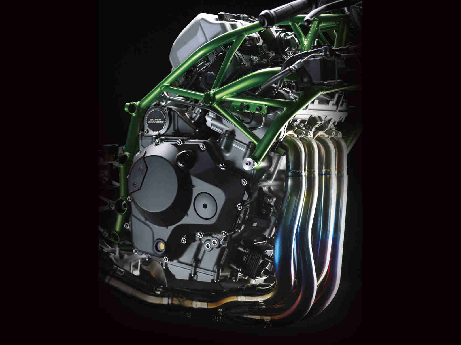 A Kawasaki motorcycle engine against a black background