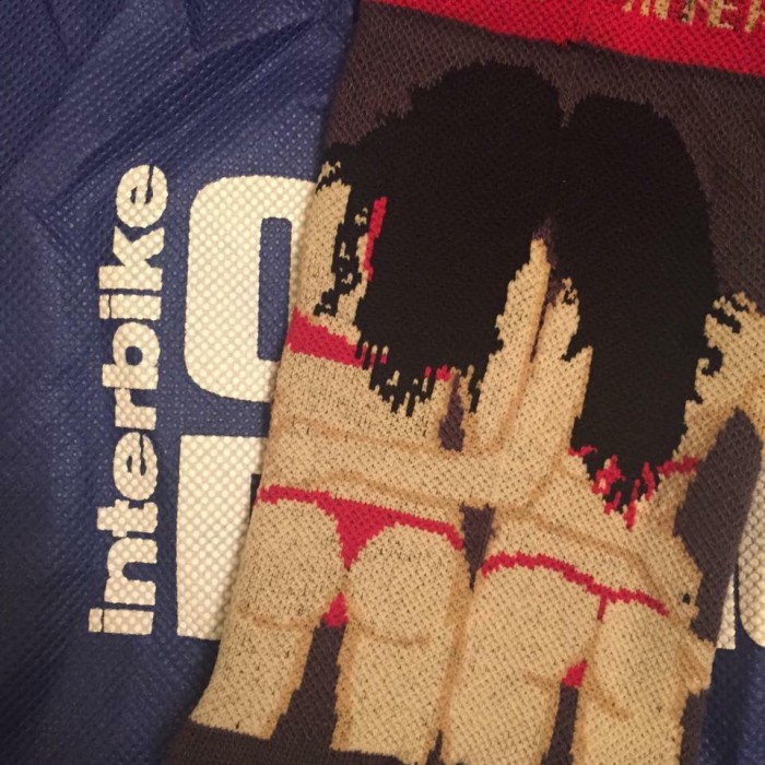 Image of a pair of socks with 2 women on them, on top of an Interbike bag