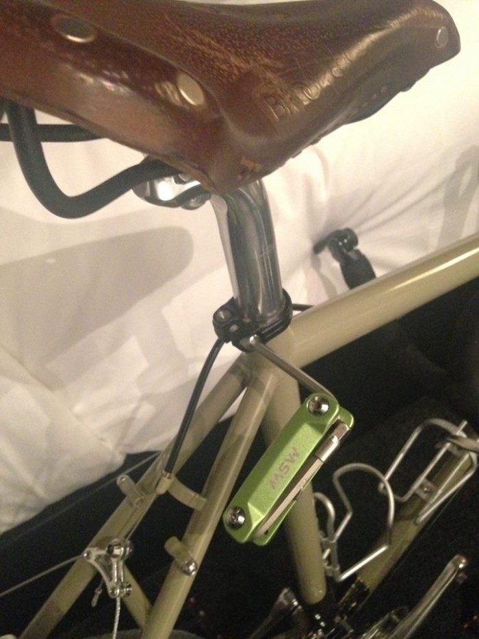 Cropped, right side view of a hex wrench tool, inserted into the bolt of a seat post clamp, on a Surly bike