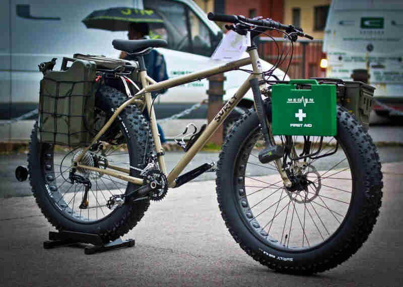 Surly Moonlander fat bike with rescue gear on racks - sand - right side view -  parked on a sidewalk