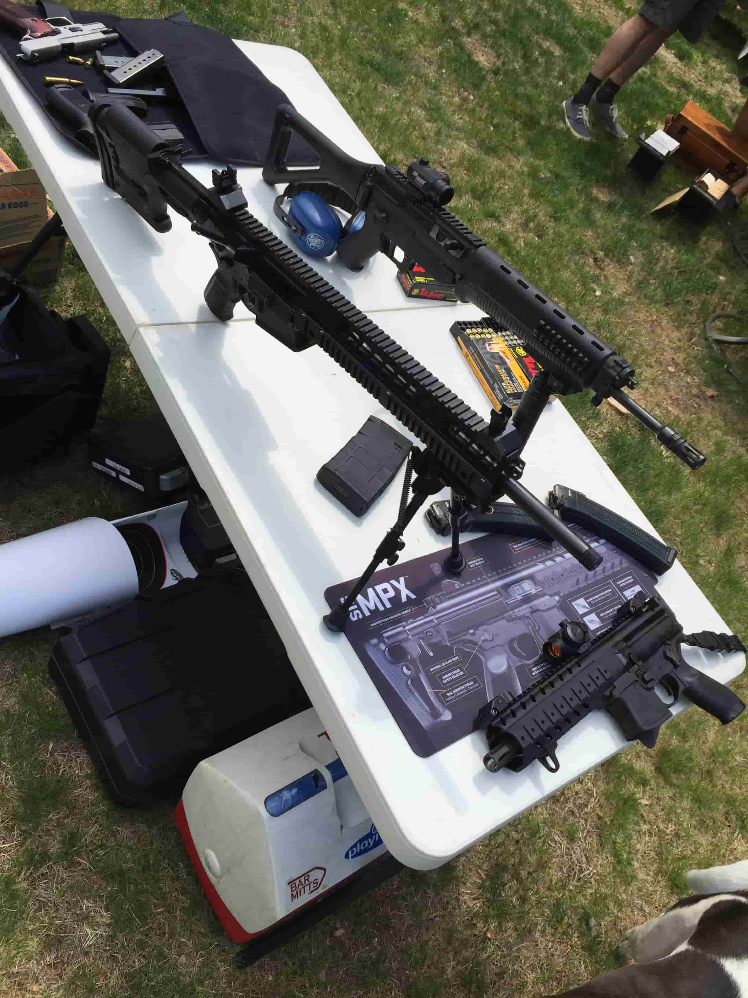 Distorted, downward view of a table with firearms on it