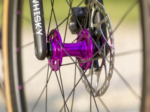 Close up of Whisky carbon fork and anodized purple Chris King front hub