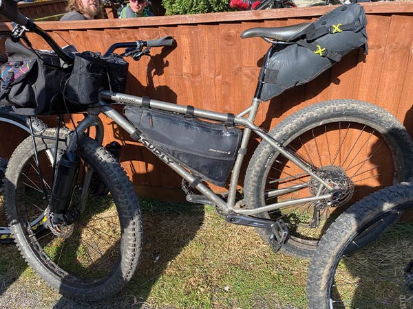 Gray Surly mountain bike with front rack and Porter House bag, frame bag, and seat pack