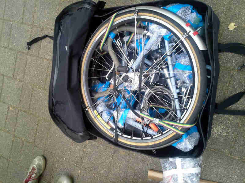 Downward view of a disassembled bike, packed inside of a Surly bike travel bag