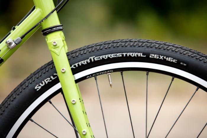 Zoom in of Surly Disc Trucker bike fork with Surly ExtraTerrestrial tires on Alexrims