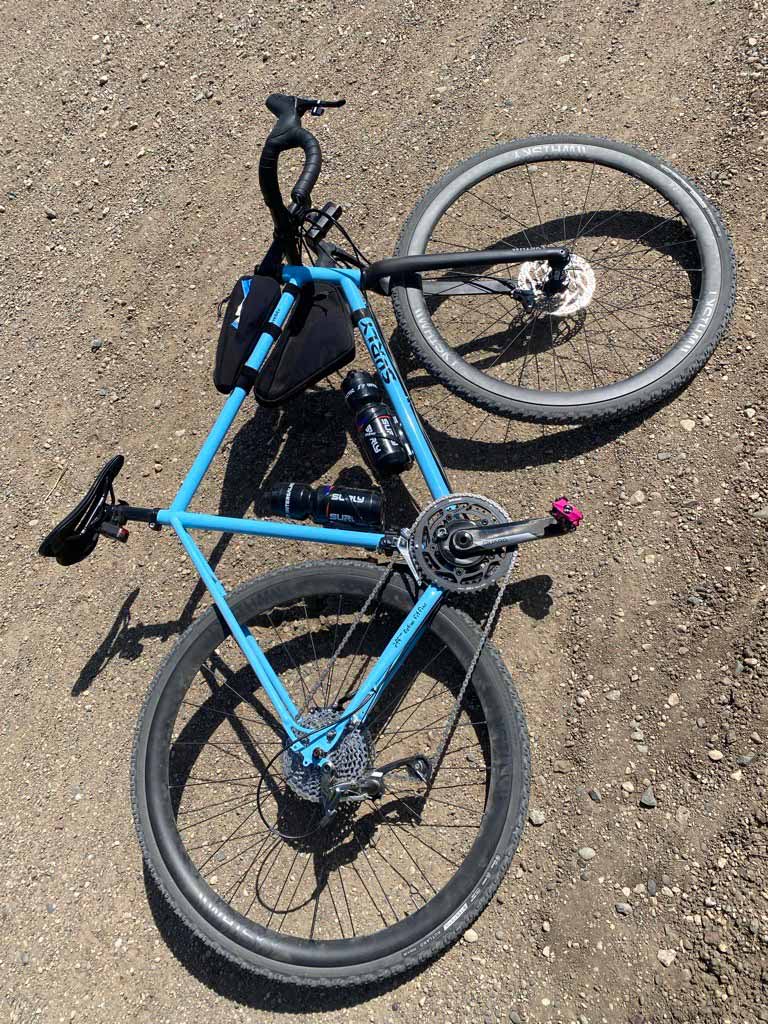 Blue Surly Preamble bike laying on gravel road
