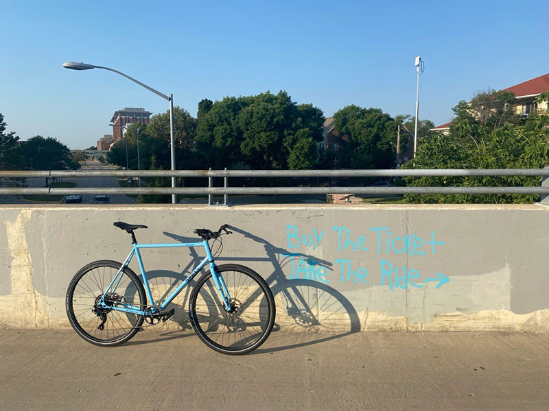 Blue Surly Preamble bike leaning against bridge