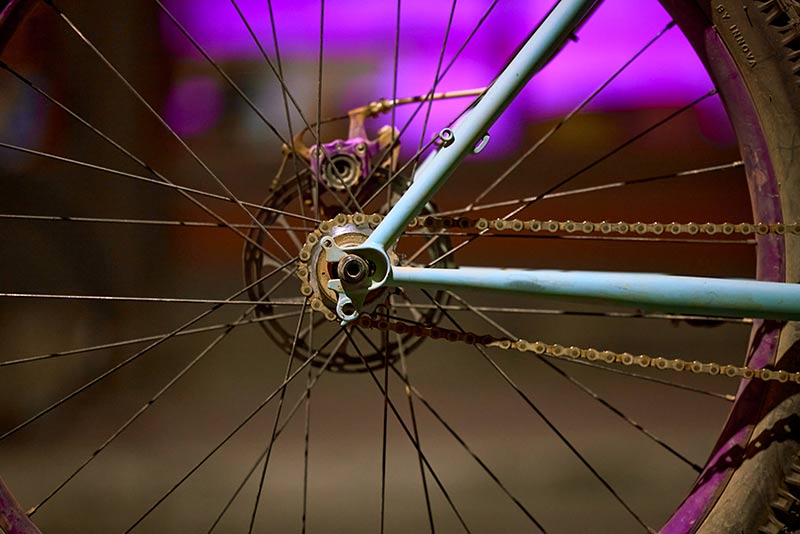 Detail of Paul's custom Surly Krampus focus on rear wheel, single speed cog, rear brake caliper, and rotor