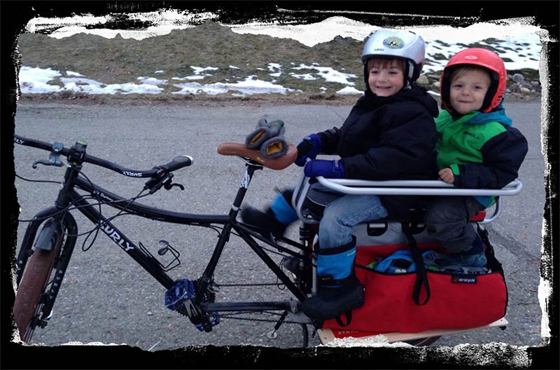Surly Big Dummy loaded with two children and gear on paved road