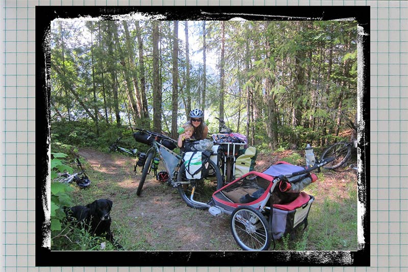Athena with child on forest trail and fully loaded bikes with dog and child trailer