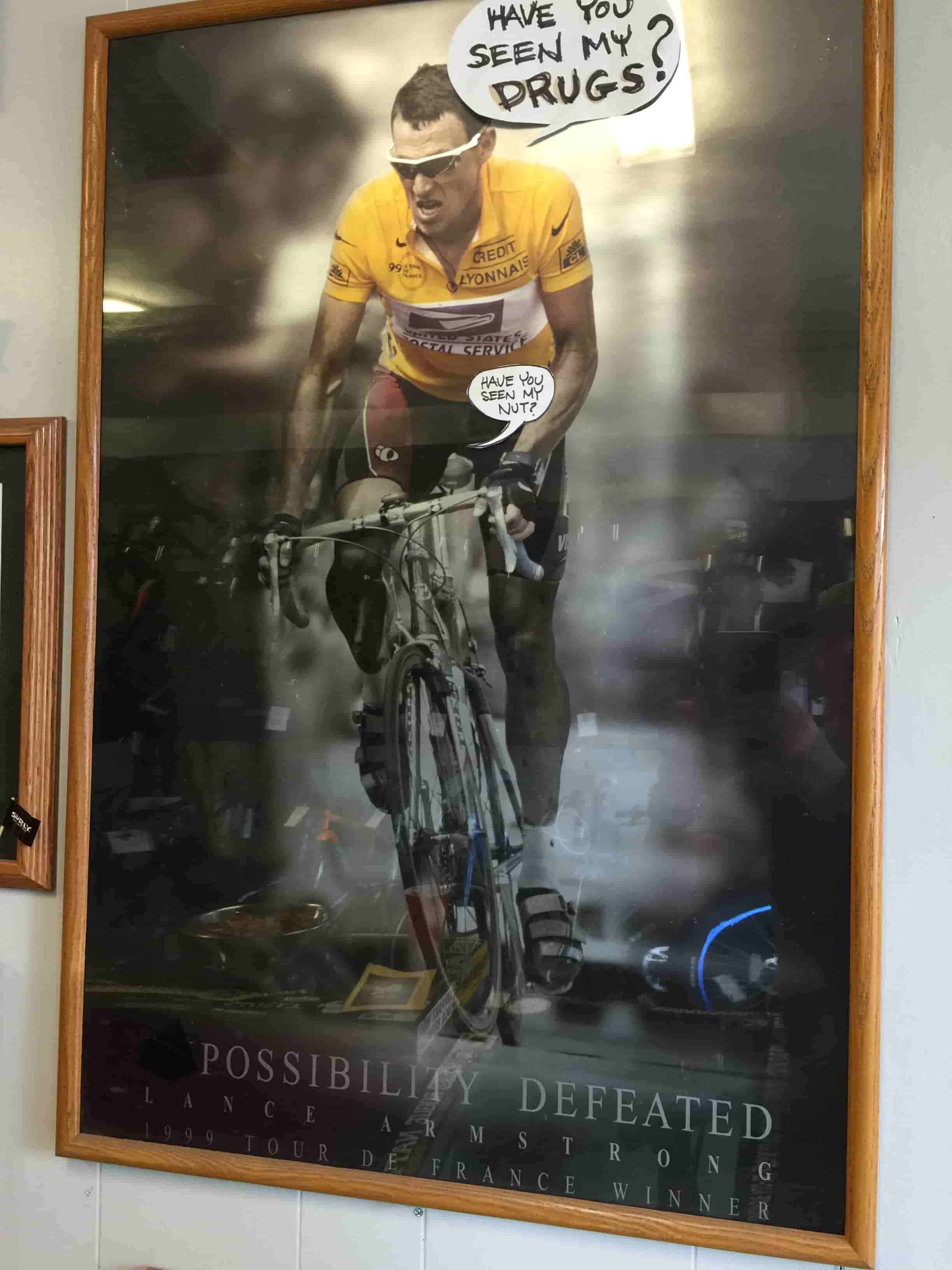 Framed posted of a front view of cyclist Lance Armstrong, riding a bike